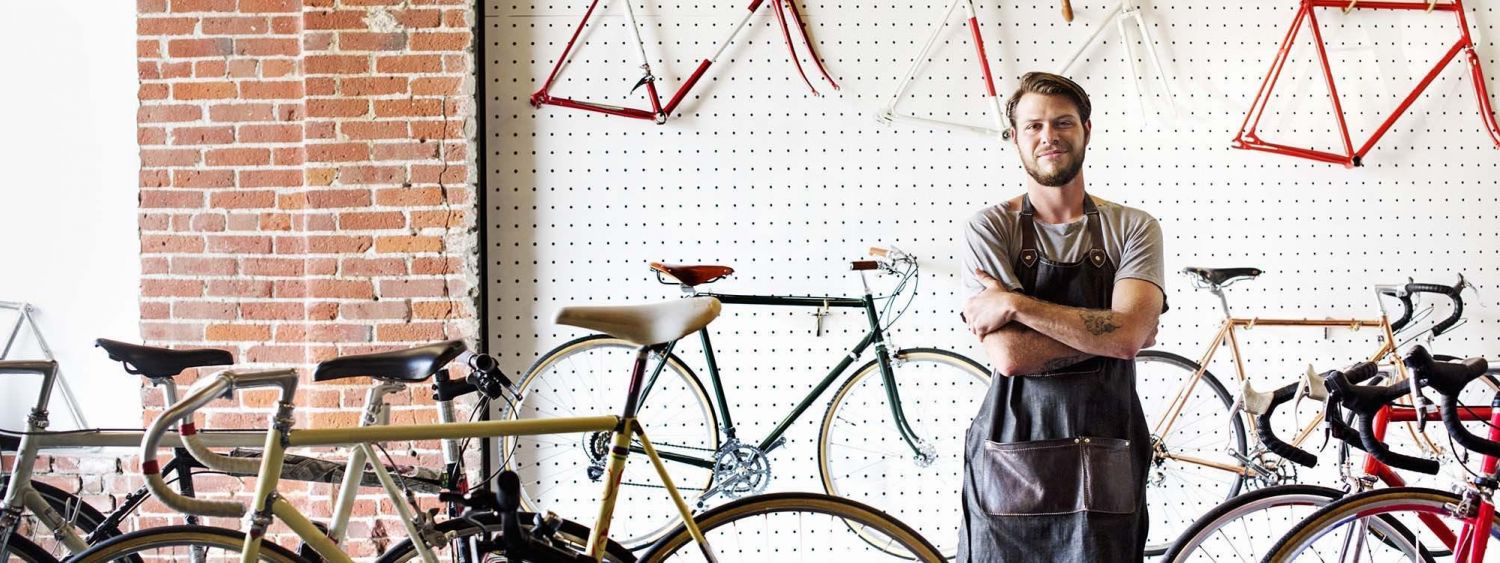 Man standing infront of bikes at a workshop